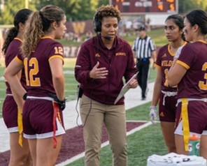 Coach and team on the field